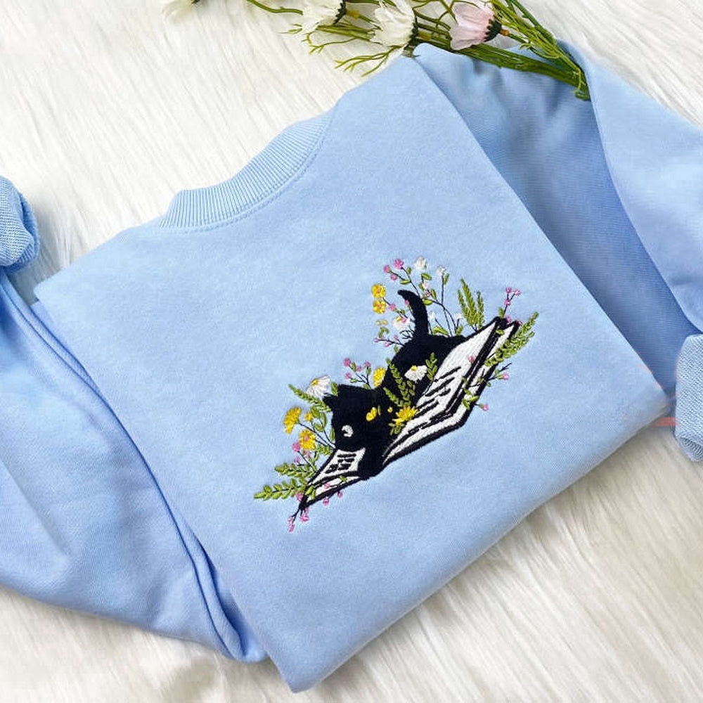 Embroidered Custom Sweatshirts, Cute Cat Lying On Book With Flower Embroidered Sweatshirt Gift For Christmas, Christmas Gift